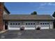 Three-car garage with white doors and landscaping at 930 River Rd, Columbus, IN 47203