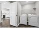 Bright laundry room with washer, dryer, wire shelving and wood-look flooring at 943 Aurora Ln, Franklin, IN 46131