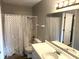 Clean bathroom, featuring a shower/tub combo, vanity, and mirror at 9518 Bay Vista E Dr, Indianapolis, IN 46250