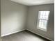 Simple bedroom with grey walls, carpet, and a large window at 9518 Bay Vista E Dr, Indianapolis, IN 46250