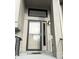Modern front door with storm door and updated lighting at 9518 Bay Vista E Dr, Indianapolis, IN 46250