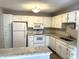 White kitchen with granite countertops and stainless steel appliances at 9518 Bay Vista E Dr, Indianapolis, IN 46250