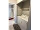 Convenient laundry room with washer, dryer, and shelving at 9518 Bay Vista E Dr, Indianapolis, IN 46250