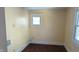 Empty bedroom with hardwood floors and a small window, ready for your personal touch at 1052 N Mount St, Indianapolis, IN 46222