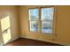 Bright bedroom with hardwood floors and large window offering a view of the backyard at 1052 N Mount St, Indianapolis, IN 46222