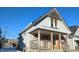 Charming house with wooden porch and gray siding at 1052 N Mount St, Indianapolis, IN 46222