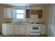 Kitchen with white cabinets and gas stove at 1052 N Mount St, Indianapolis, IN 46222