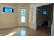 Spacious living room with hardwood floors and access to entryway at 1052 N Mount St, Indianapolis, IN 46222