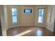 Bright living room featuring hardwood floors and large windows at 1052 N Mount St, Indianapolis, IN 46222