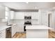 Modern kitchen with white cabinets, stainless steel appliances and an island at 10767 Red Pine Dr, Fishers, IN 46037