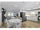 Open kitchen and dining area with white cabinets and stainless steel appliances at 11427 Mutz Ct, Indianapolis, IN 46229