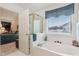 Bathroom with shower/tub combo, vanity, and window at 11537 Jagged Rock Ct, Fishers, IN 46037