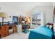 Bright bedroom with a bed, workspace, and large window at 11537 Jagged Rock Ct, Fishers, IN 46037