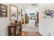 Bright entryway with hardwood floors, mirror, and wooden cabinet at 11537 Jagged Rock Ct, Fishers, IN 46037