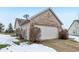 Attached garage with light beige door and brick exterior at 11537 Jagged Rock Ct, Fishers, IN 46037