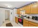 Kitchen with wood cabinets, stove, and access to other rooms at 11537 Jagged Rock Ct, Fishers, IN 46037