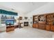 Cozy living room featuring a fireplace, built-in shelving, and large windows at 11537 Jagged Rock Ct, Fishers, IN 46037