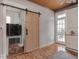 Bright laundry room with barn door, washer and dryer at 127 S Butler Ave, Indianapolis, IN 46219