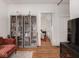 Living room with hardwood floors, a large TV, and built-in shelving at 127 S Butler Ave, Indianapolis, IN 46219