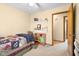 Bright bedroom with a twin bed, built-in shelving, and closet at 13481 E 300 S, Columbus, IN 47203