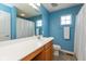 Bright bathroom with a white vanity and blue walls at 15256 Harmon Pl, Noblesville, IN 46060