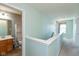 Upstairs hallway with light teal walls and carpet at 15256 Harmon Pl, Noblesville, IN 46060
