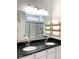 Modern bathroom featuring double sinks, granite countertops, a large mirror, and a glass-enclosed shower at 15759 Hargray Dr, Noblesville, IN 46062
