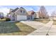 Lovely home showcasing a well-maintained lawn, spacious driveway, and classic architectural details at 15759 Hargray Dr, Noblesville, IN 46062