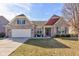 Charming brick home featuring a two-car garage, manicured lawn, and inviting front porch at 15759 Hargray Dr, Noblesville, IN 46062