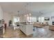 Spacious living space with an open floor plan to a modern kitchen and dining area at 15759 Hargray Dr, Noblesville, IN 46062