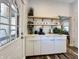 Coffee bar features white cabinets, wood shelves, and a quartz countertop at 1604 Hoyt Ave, Indianapolis, IN 46203