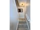 Staircase with carpeted steps, neutral walls, and a simple handrail at 1604 Hoyt Ave, Indianapolis, IN 46203