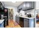 Gray kitchen cabinets, stainless steel appliances, and a view into the laundry room at 1763 Wellesley Ln # 3G, Indianapolis, IN 46219