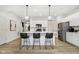 Modern kitchen island with seating, white cabinets, and hardwood floors at 18721 Moray St, Westfield, IN 46074