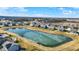 Aerial view of a community with a scenic pond and well-maintained homes at 19226 English Lake Ln, Noblesville, IN 46062