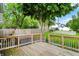 Large wooden deck with railing offering a view of the private backyard and surrounding trees at 207 E Ohio St, Fortville, IN 46040