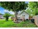 Secluded backyard with a covered hot tub, wooden deck, and lush green lawn at 207 E Ohio St, Fortville, IN 46040