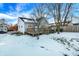 Cozy backyard with deck, hot tub, and snowy landscape at 207 E Ohio St, Fortville, IN 46040