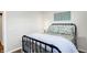 Simple bedroom with a metal bed frame and floral bedding at 207 E Ohio St, Fortville, IN 46040
