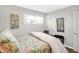 Bright bedroom with a queen bed and floral bedding at 207 E Ohio St, Fortville, IN 46040