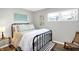 Cozy bedroom featuring a metal bed frame and floral bedding at 207 E Ohio St, Fortville, IN 46040