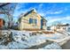 Tan house with blue shutters, snowy yard, winter scene at 207 E Ohio St, Fortville, IN 46040