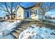 Steps leading to charming home's entrance, snow on ground at 207 E Ohio St, Fortville, IN 46040