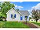 Charming single-story home with blue accents and landscaped front yard, perfect curb appeal at 207 E Ohio St, Fortville, IN 46040