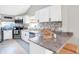 Updated kitchen, white cabinets, granite, tile floor at 207 E Ohio St, Fortville, IN 46040