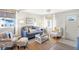 Cozy living room features a blue sofa and armchairs at 207 E Ohio St, Fortville, IN 46040