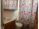 Small bathroom with shower/tub and wood vanity at 208 Winding Dr, Alexandria, IN 46001