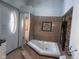 Bathroom features a large jetted tub and stone wall at 208 Winding Dr, Alexandria, IN 46001