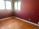 Bright bedroom with hardwood floors and red walls at 208 Winding Dr, Alexandria, IN 46001