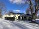 Yellow ranch house with a two-car garage and snowy yard at 208 Winding Dr, Alexandria, IN 46001